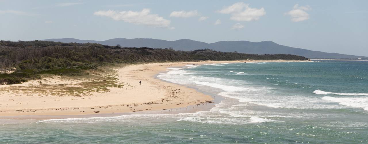 A landscape image of a sunny Mallacotta Beach