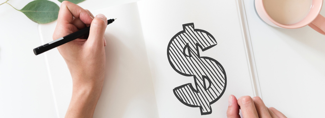 Hand drawing dollar sign in book.