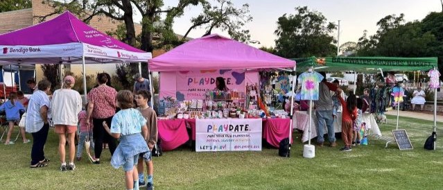 A group of marquees in a park at a community event