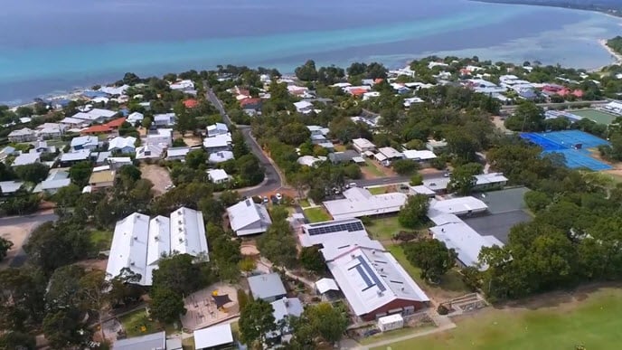 Birds eye view of Dunsborough area with houses and ocean.