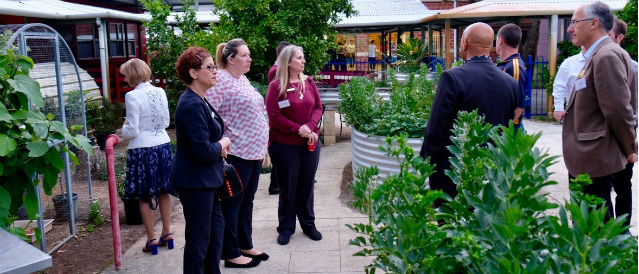 Canning Vale Community Bank Branch staff inspecting a community garden funded by the Community Bank company.