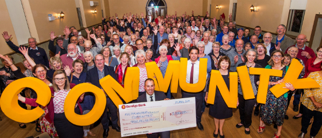 Members of the Maldon community group image holding COMMUNITY letters and novelty cheque.