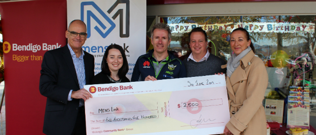 Community Bank directors and representative of local community groups holding a novelty cheque spelling out the word 'community'.