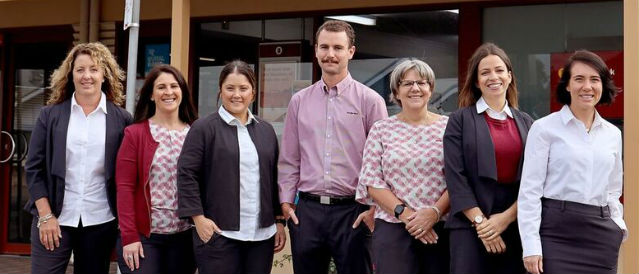Robe staff in uniform standing outside the Robe Community Bank Branch.