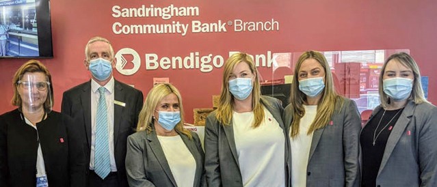 The team from Community Bank Sandringham standing in the branch wearing face masks