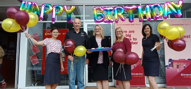 Branch staff standing out the front of Pomona branch with balloons celebrating the 2nd birthday of Pomona Bendigo Bank.