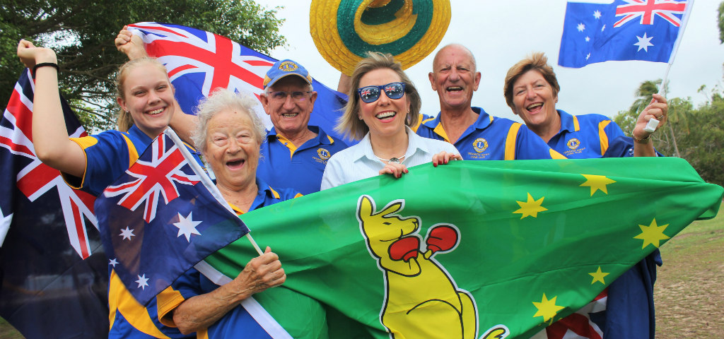 Group of people pictured with Australia Day flags and hats celebrating.