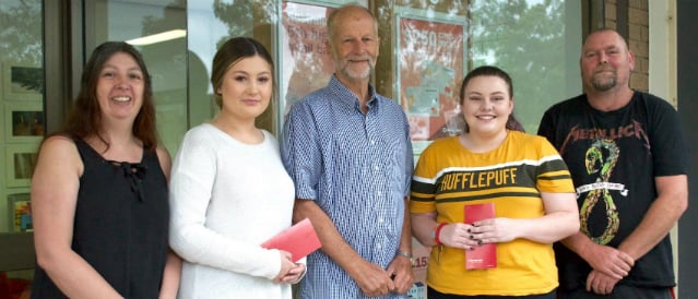 Warburton and Yarra Junction Community Bank Branch scholarship recipients with Community Bank directors standing outside the branch.
