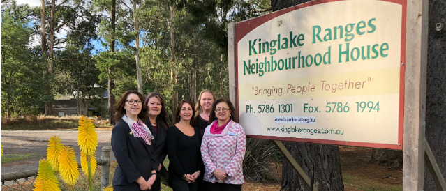 Kinglake Community Bank Branch staff standing outside the Neighborhood House which has received funding from the branch.