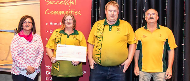 Members of Kinglake Cricket Club receive a sponsorship cheque from a Kinglake branch staff member