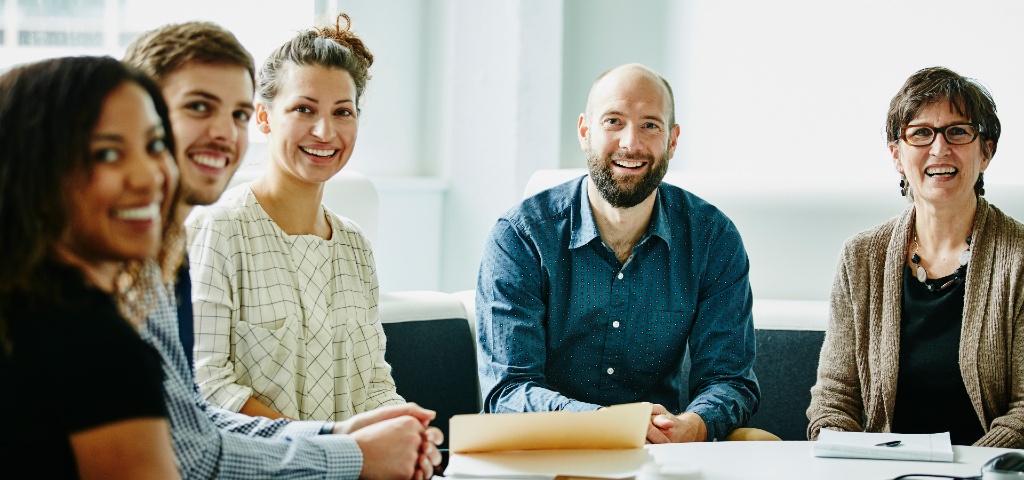 Image of a group of people sitting around a table having a meeting