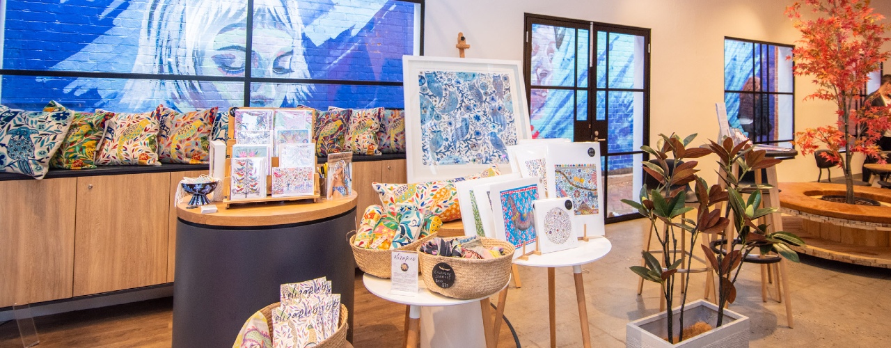 Artwork being displayed on the tables in our retail pop-up area