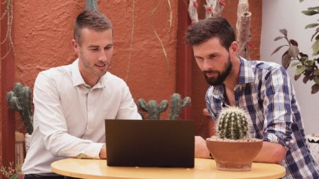 Business banker and customer looking at laptop