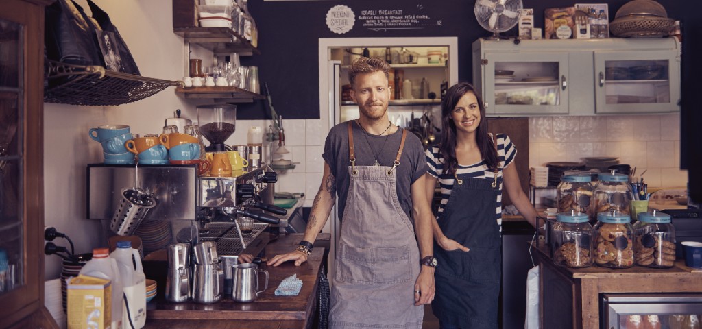 Male and female working in cafe