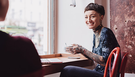 Not-for-profit employee enjoying the coffee they purchased with their fringe benefits card.