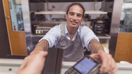 Customer completing a transaction on a merchant terminal