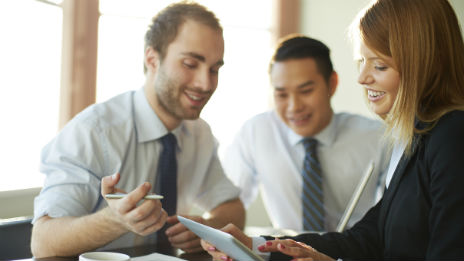 Banker showing a couple information on a tablet.