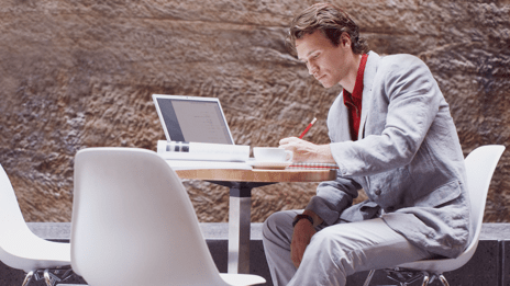 Man sitting at table with computer